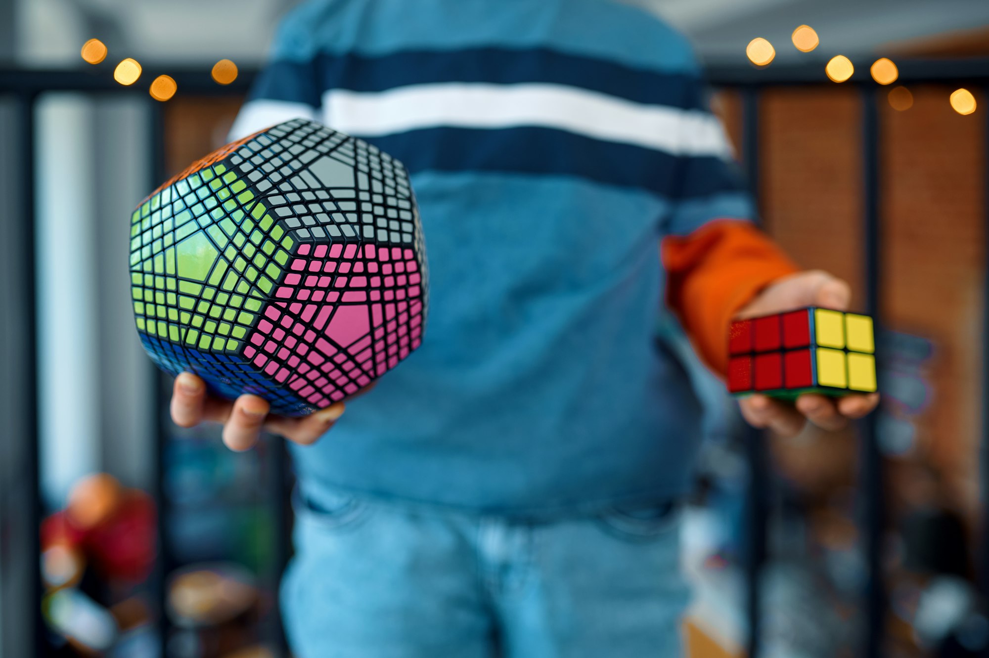 Young boy holds puzzle cubes in his hands
